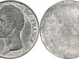 a close up of a silver coin with a face of a man