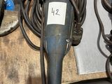 a close up of a drill and other tools on a table