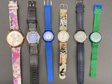 several different watches are lined up in a row on a table