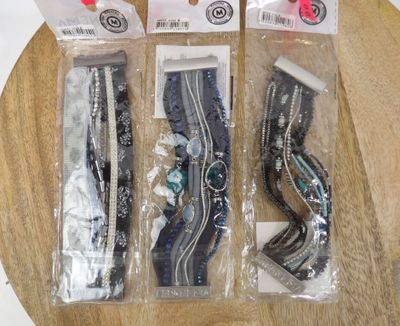 three pairs of scissors in the packaging on the table