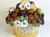 a vase with a bunch of fruits and nuts in it