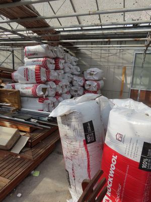 many bags of cement sitting on the floor in a warehouse