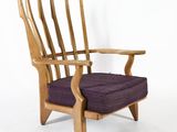 an image of a wooden chair with purple cushion on a white background