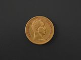 a close up of a gold coin on a black surface