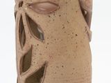 a brown vase with a flower design on it
