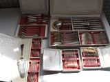 a box of silverware on a table with other silverware in it