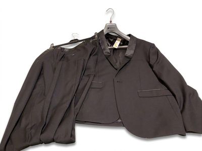 a suit and tie on a hanger on a white background