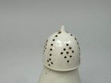 a white salt and pepper shaker with holes on it