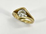 a close up of a diamond ring on a white surface