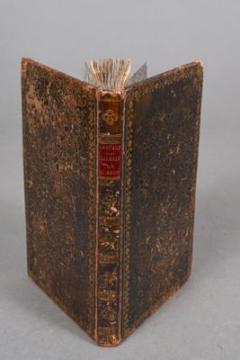 an old book that is open on a table