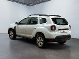 the rear end of a white dacia parked in a white room