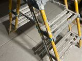 a ladder that is sitting on the floor next to a table