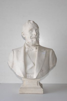 a bust of a man in a tuxedo sitting on a table