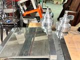 several pieces of metal are stacked on top of a table in a workshop