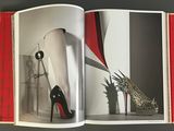 an open book with a picture of a pair of high heeled shoes