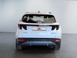 the rear end of a white suv parked in a showroom