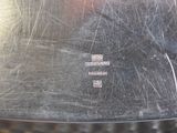 a close up of a silver plate with a metal handle