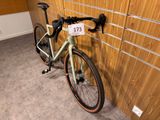 a bike leaning against a wall with a price tag on it