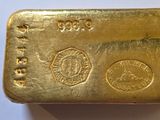 an image of a gold bar on a white surface