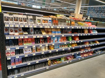 a lot of snacks on the shelves in the store