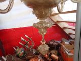 a picture of a gold vase on a table in a room