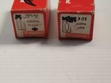 two red boxes sitting on top of a white table next to each other