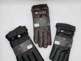 three pairs of black gloves on a white surface