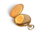 a gold pocket watch with a gold case on a white surface