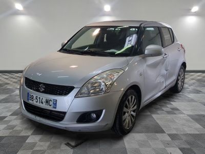 the small silver car is parked on a checkered tile floor
