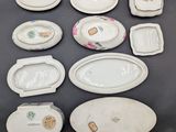 many different types of porcelain dishes and bowls on the table