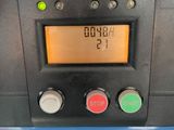 a close up of a parking meter with a clock on it