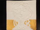 an image of a white and yellow tile with a woman ' s face on it