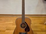 a guitar that is sitting on the floor in the room