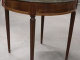 a small table with a glass top on a white floor