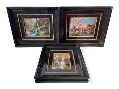 three framed paintings of animals and trees in a black frame