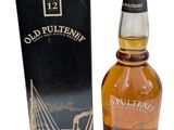 a bottle of old pultenen whisky next to a box