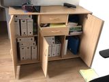 a desk with a computer on top of it in a room