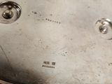 a silver pan with a handle on a table