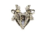 two silver heart shaped brooches on a white background
