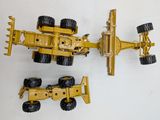two toy vehicles that are sitting on a white surface