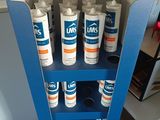 several cans of luks are stacked on a shelf in a room