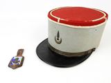 a hat and a cell phone on a white surface