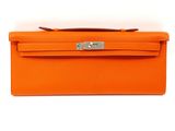 an orange leather wallet with a metal clasp on it