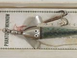 a small fishing lure in a box on a table