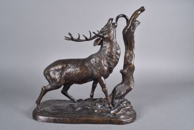 statue of a stag on a rock with a tree in the background