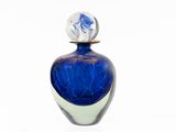 a blue glass bottle with a white base and a blue and white design on it
