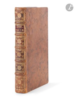 an old book sitting on top of a white surface