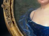 portrait of a woman in a blue dress in a gold frame