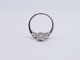 a close up of a silver ring on a white surface
