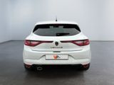 the rear end of a white car in a white room